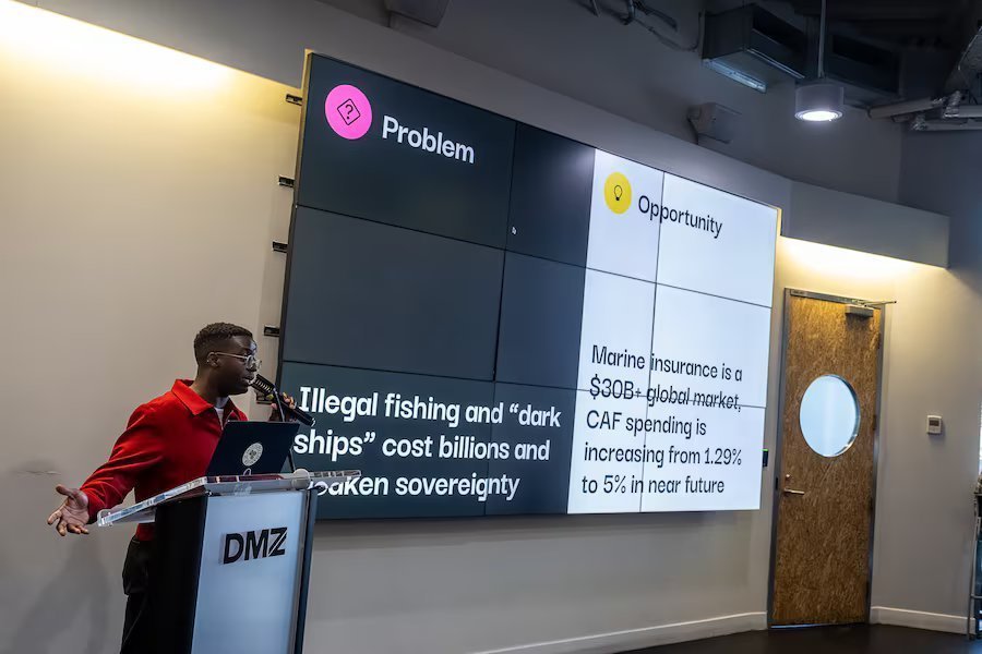 George Kavuma presenting Drumlin from the podium at the DMZ Defence Tech Hackathon.